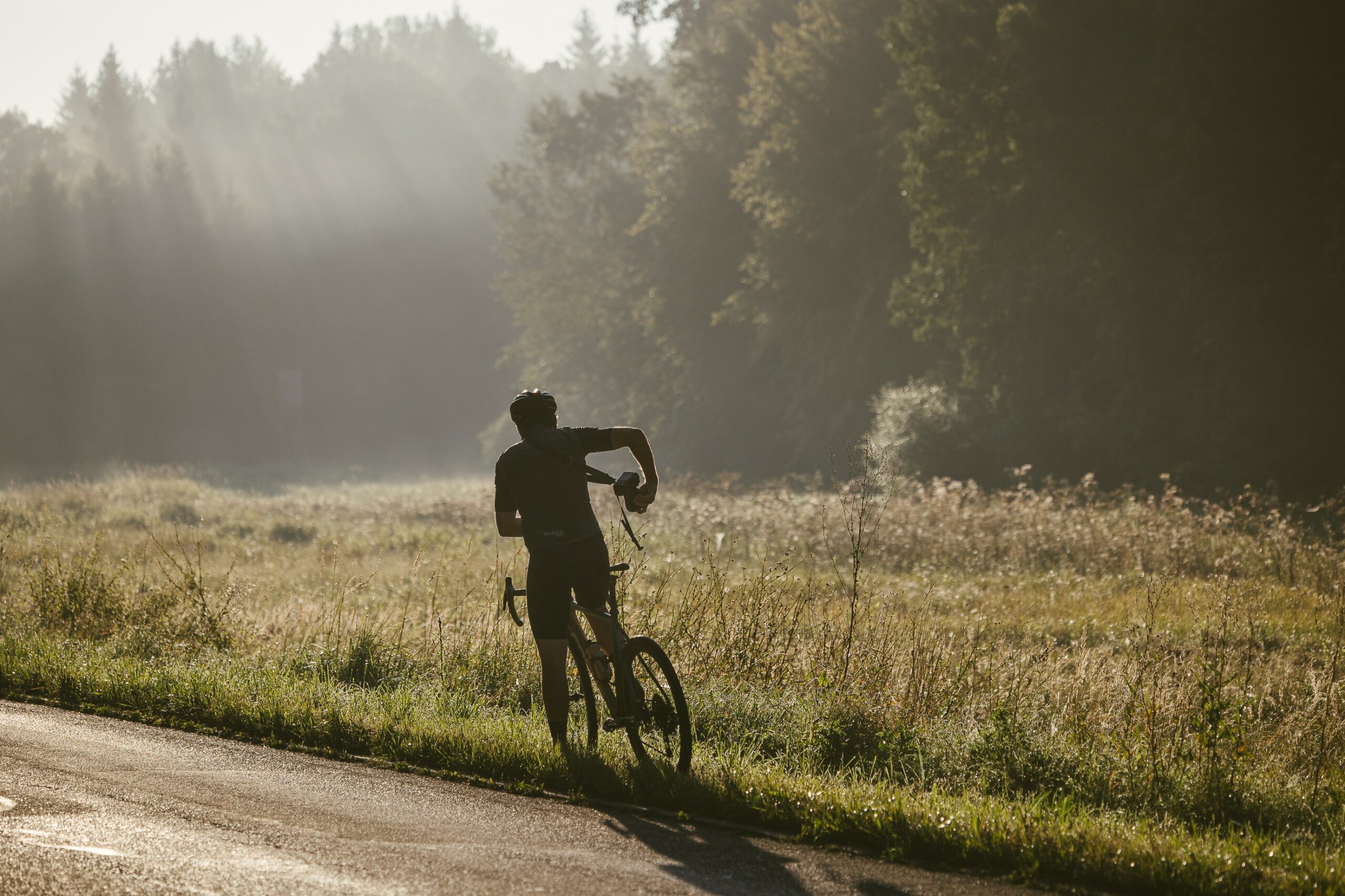 Man cycling on bike in field